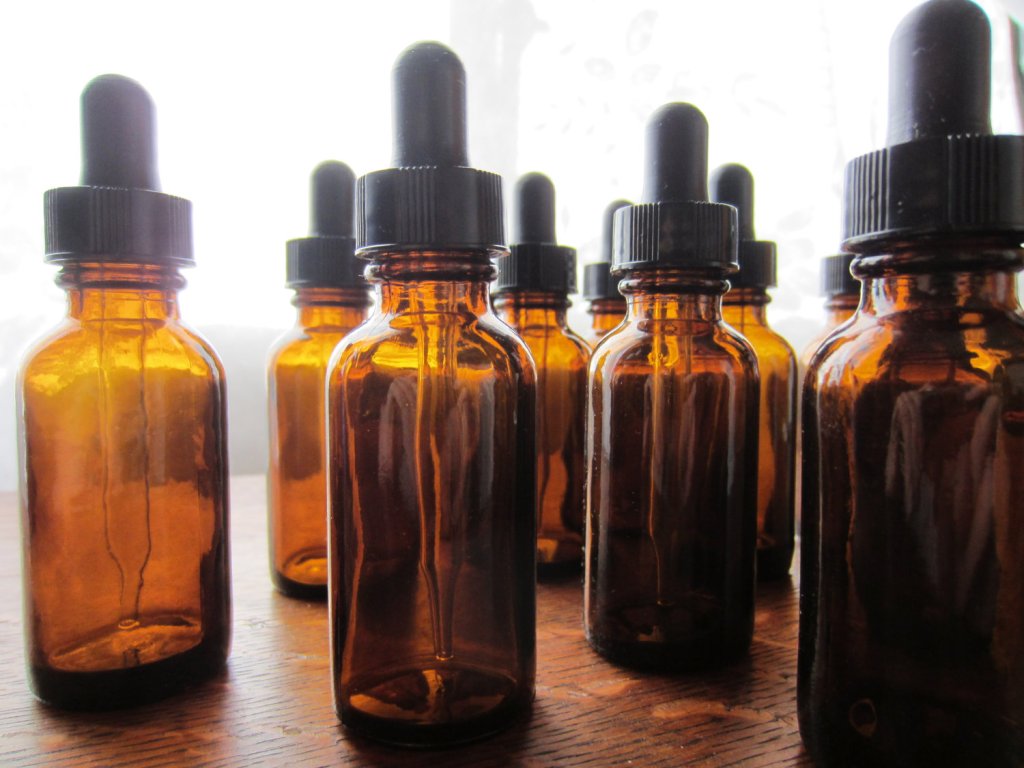 A table with empty amber tincture bottles close up.