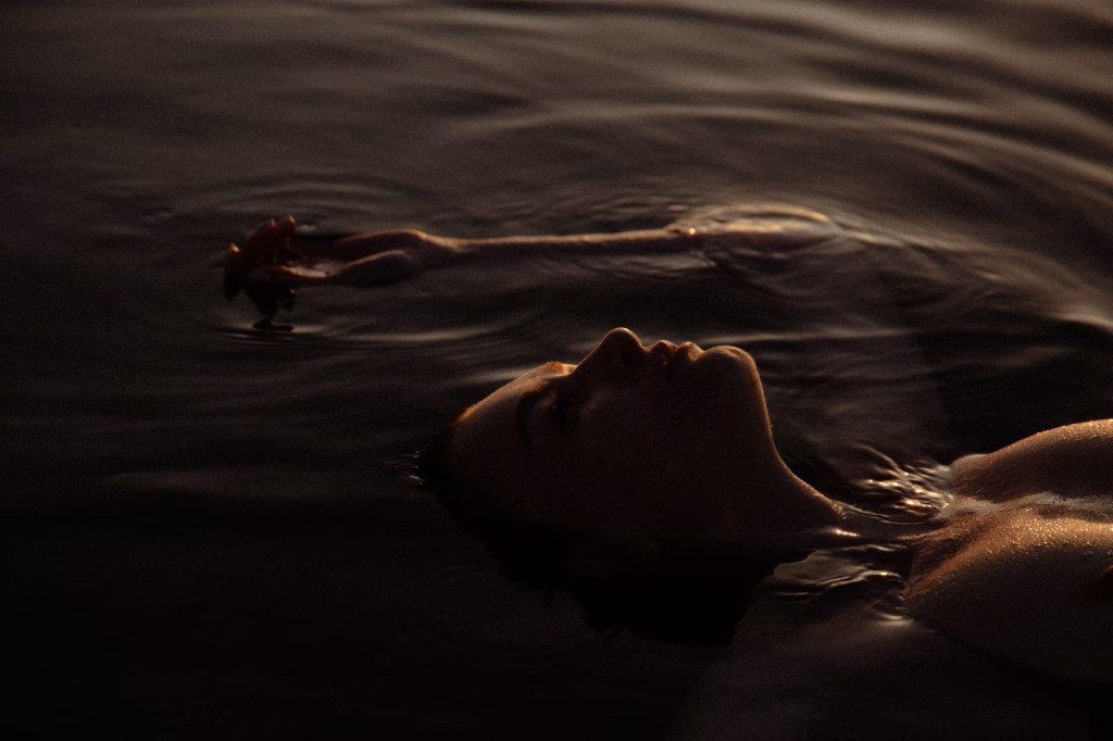 woman peacefully floating in water.