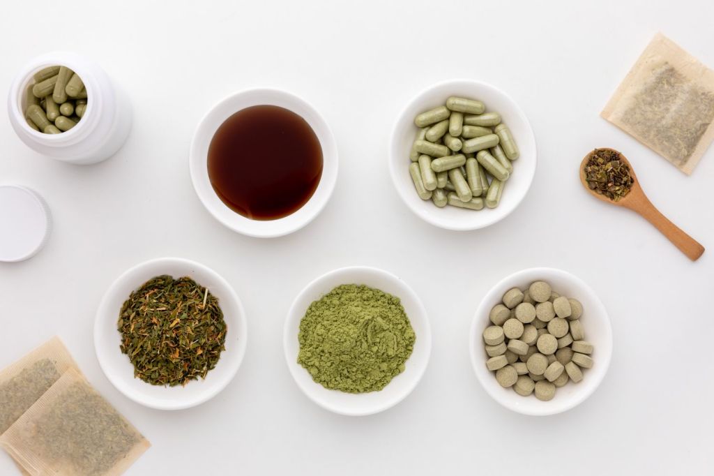 Alfalfa herb in different forms in overhead view on white background.